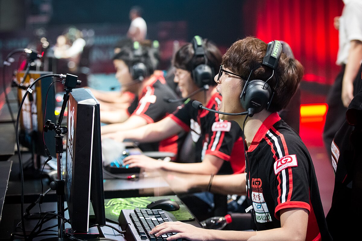 group of esports players in matching jerseys, intensely