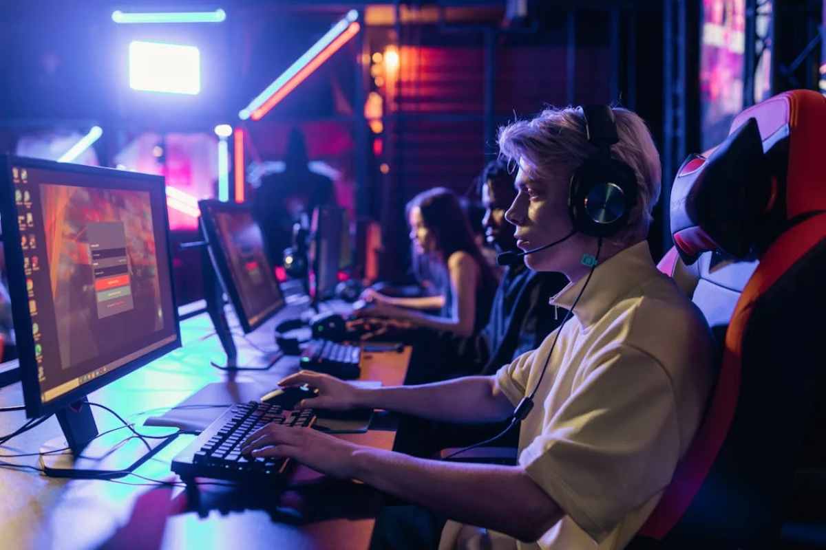 group of gamers focused on their screens in a vibrant esports arena