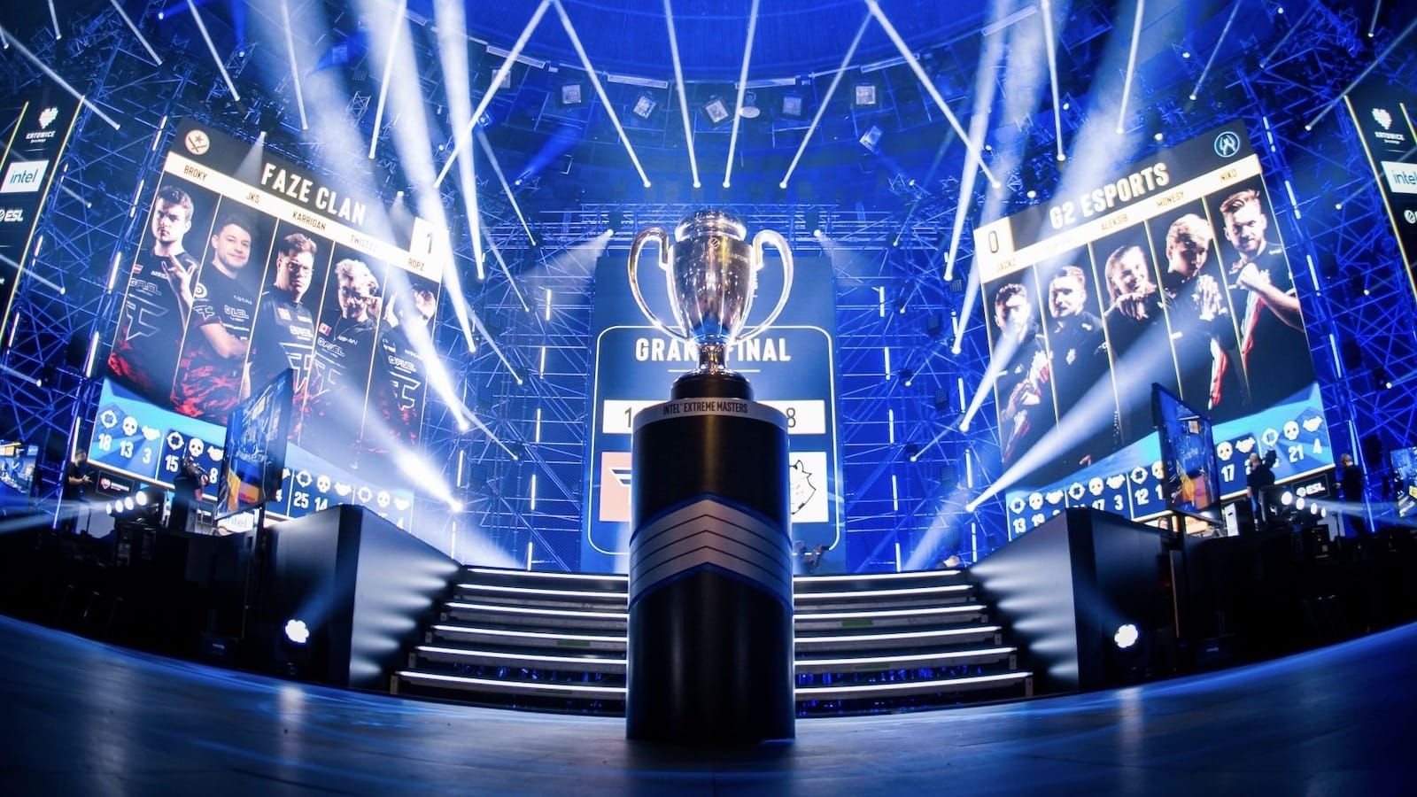 grand esports arena featuring bright lights, a large trophy at center