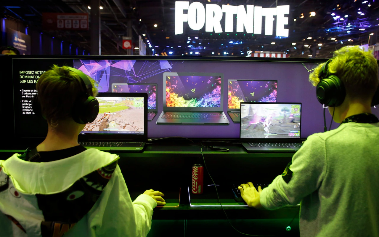 young gamers play Fortnite on laptops at a gaming event